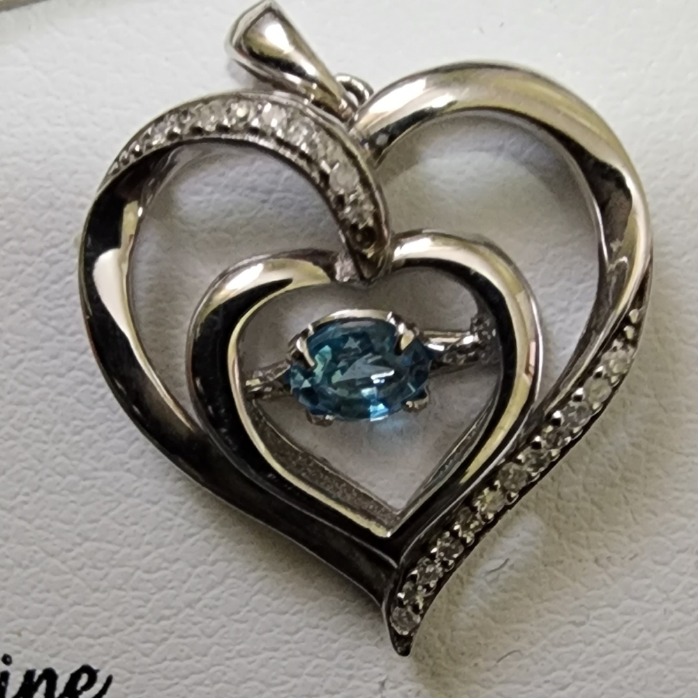 Dancing blue topaz with diamond accents on sterling silver